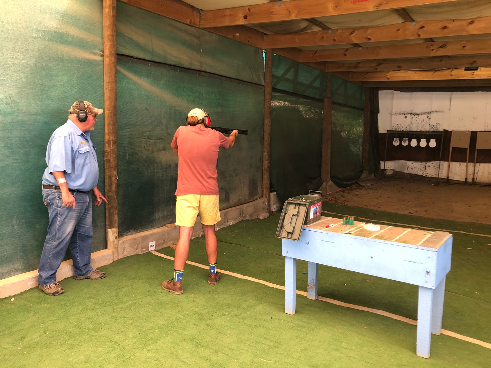 Andre showing student how to shoot